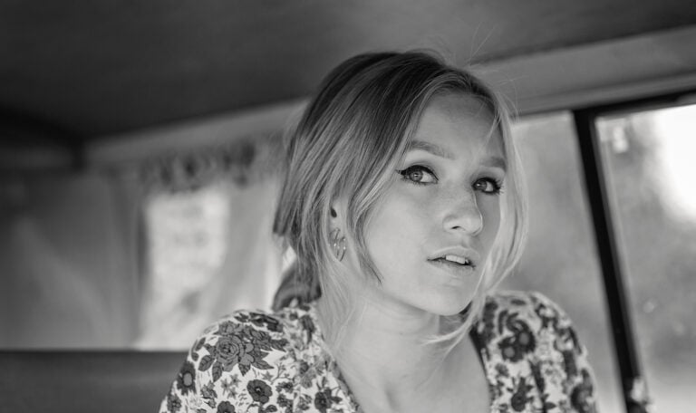 Elegant black and white portrait of a young woman with striking eyes, taken by Jo Worthington photography.